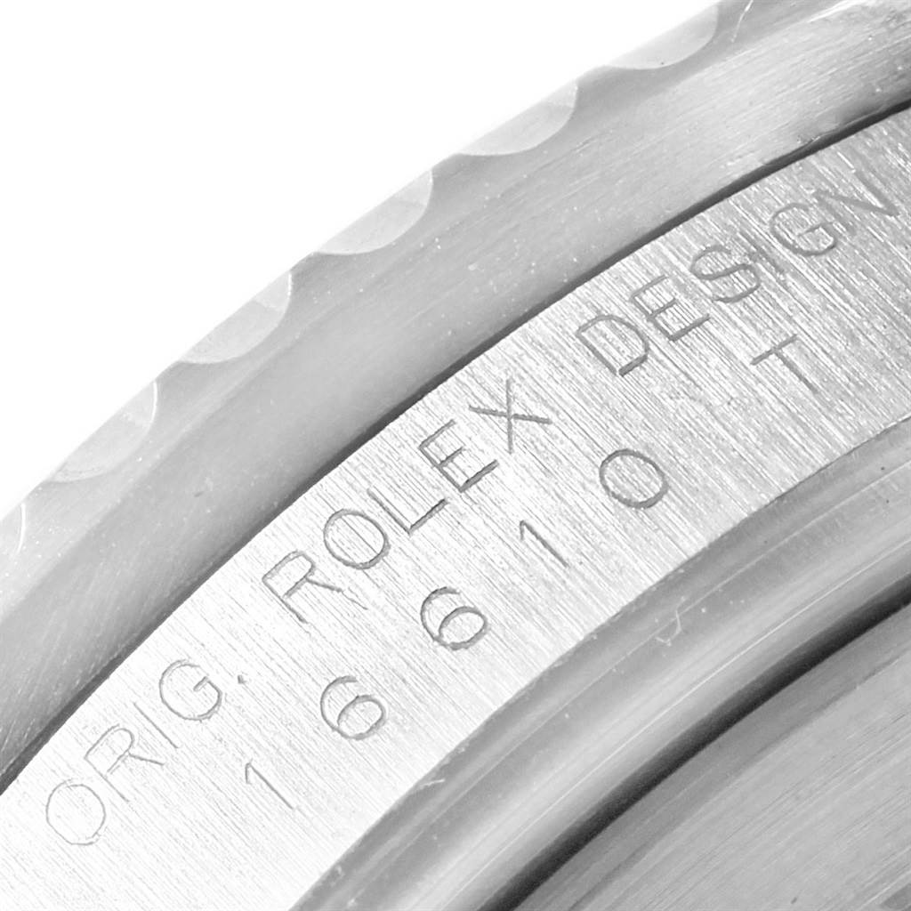 Close-up angled view of the Rolex Submariner 16610 Men's Stainless Steel Black Dial 16610 Men's Stainless Steel Black Dial's bezel and engraved serial number area.