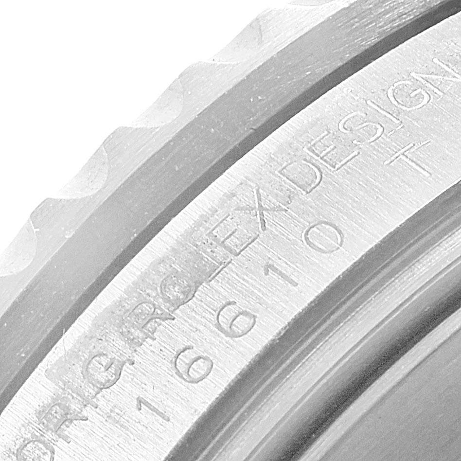 The image shows a close-up angle of the bezel and inner ring containing the model and serial number of a Rolex Submariner 16610LV Men's Stainless Steel Black Dial 16610LV Men's Stainless Steel Black Dial watch.