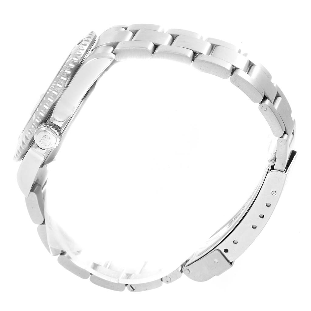 This side view of the Rolex Submariner 16610LV Men's Stainless Steel Black Dial 16610LV Men's Stainless Steel Black Dial watch showcases the crown, bezel, and metal bracelet.