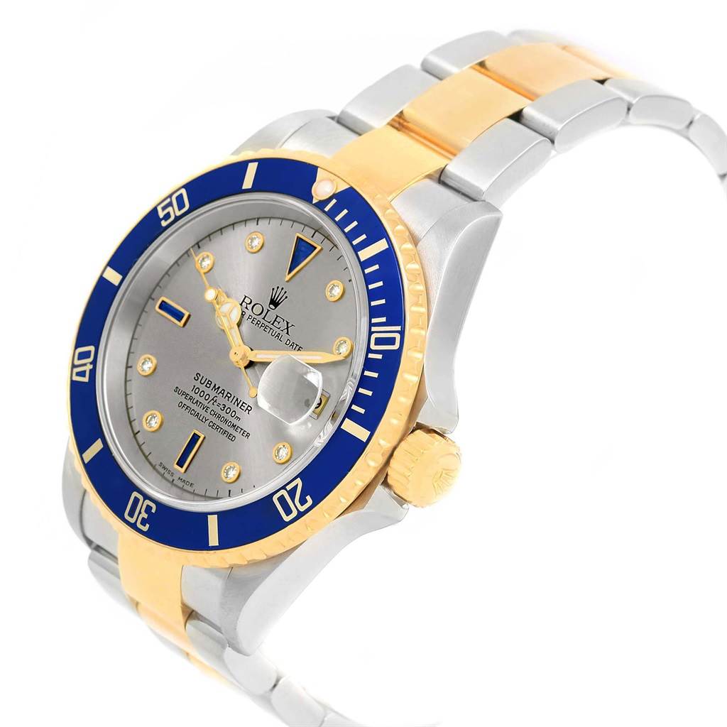 The image shows a Rolex Submariner 16613 Men's Steel and Gold (two tone) Grey Dial 16613 Men's Steel and Gold (two tone) Grey Dial watch at a three-quarter angle, displaying the dial, bezel, crown, and part of the metal bracelet.