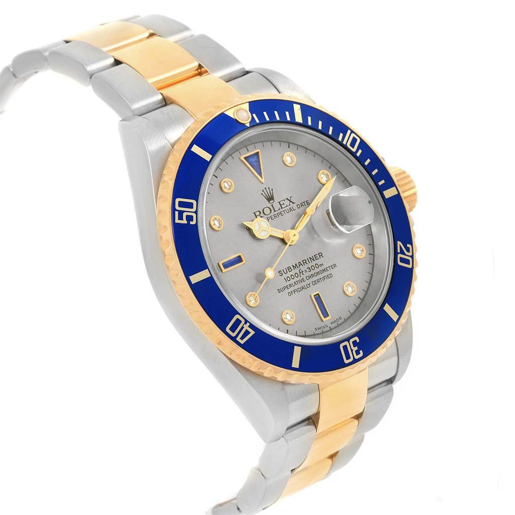 The image shows a Rolex Submariner 16613 Men's Steel and Gold (two tone) Grey Dial 16613 Men's Steel and Gold (two tone) Grey Dial watch at a 3/4 angle, highlighting the dial, bezel, and part of the bracelet.