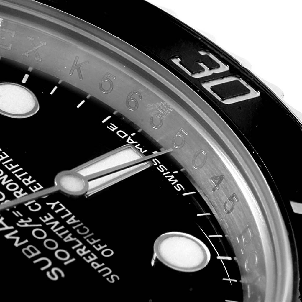 This close-up shot of the Rolex Submariner 116610 Men's Stainless Steel Black Dial 116610 Men's Stainless Steel Black Dial shows part of the dial, hour marker, and the bezel with the "30" minute mark.