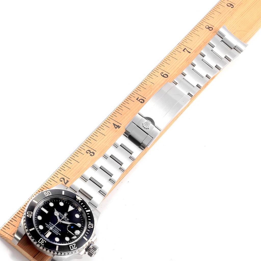 The image shows the full length of a Rolex Submariner 116610 Men's Stainless Steel Black Dial 116610 Men's Stainless Steel Black Dial watch laid flat against a ruler, displaying the face and bracelet.
