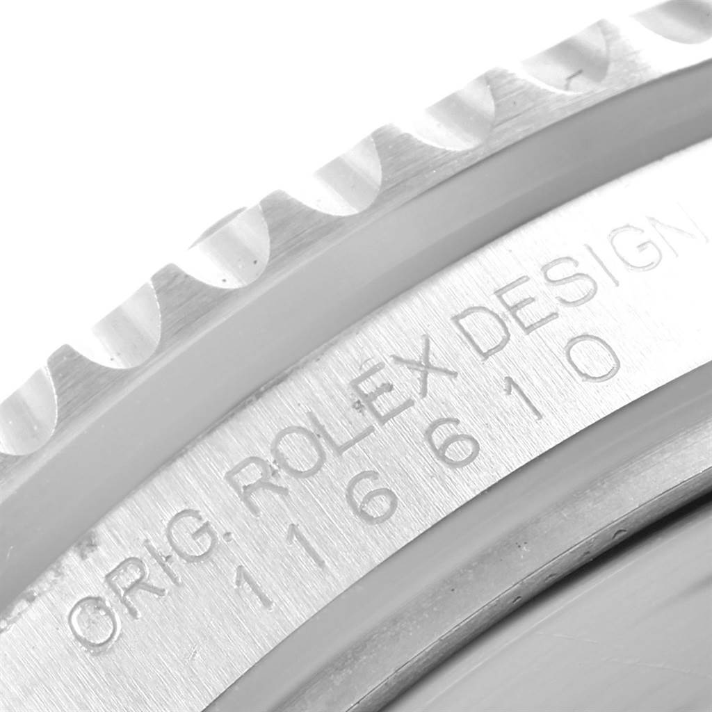 The image shows a close-up angle of the Rolex Submariner 116610 Men's Stainless Steel Black Dial 116610 Men's Stainless Steel Black Dial's bezel and engraved serial number.