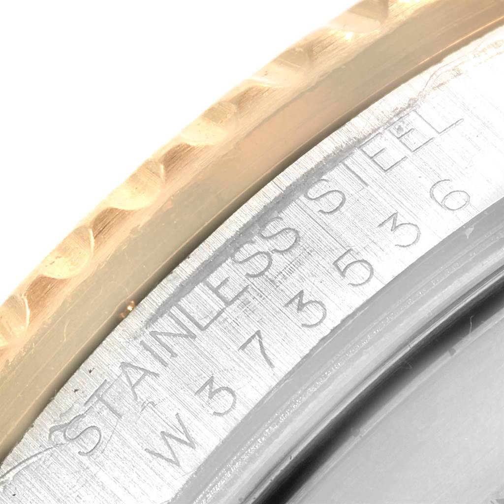 The image shows a close-up of the case side and serial number engraving on a Rolex Submariner 16613 Men's Steel and Gold (two tone) Grey Dial 16613 Men's Steel and Gold (two tone) Grey Dial watch.
