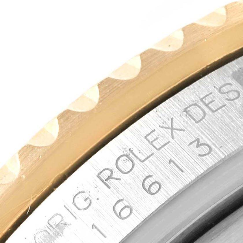 The image shows a close-up of the bezel and part of the engraved inner ring of a Rolex Submariner 16613 Men's Steel and Gold (two tone) Grey Dial 16613 Men's Steel and Gold (two tone) Grey Dial watch.