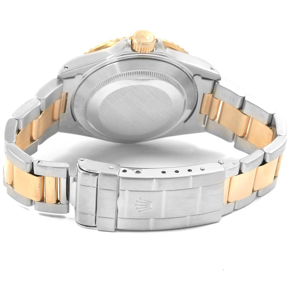 The image shows the back case and two-tone bracelet of a Rolex Submariner 16613 Men's Steel and Gold (two tone) Grey Dial 16613 Men's Steel and Gold (two tone) Grey Dial watch, with its clasp and crown visible.
