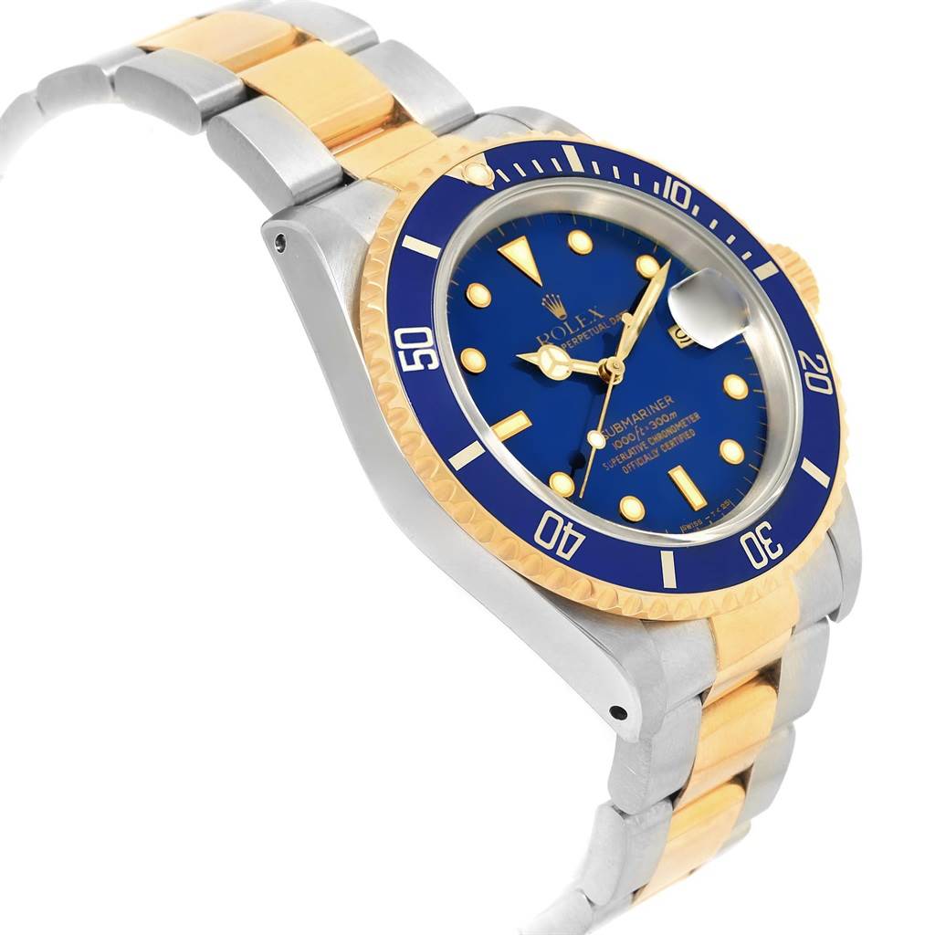 This Rolex Submariner 16613 Men's Steel and Gold (two tone) Blue Dial 16613 Men's Steel and Gold (two tone) Blue Dial watch is shown at a side angle, displaying its blue dial, bezel, and two-tone metal bracelet.