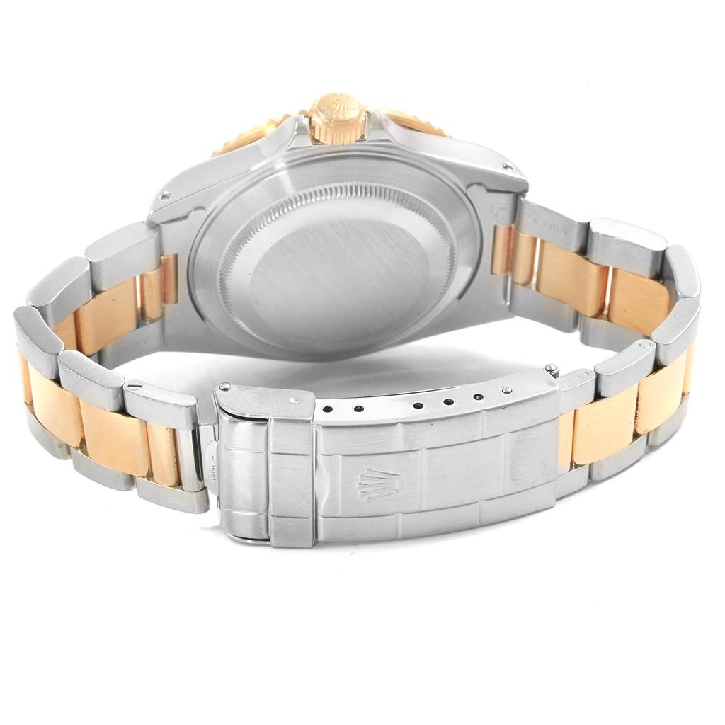 The image shows the back view of a Rolex Submariner 16613 Men's Steel and Gold (two tone) Blue Dial 16613 Men's Steel and Gold (two tone) Blue Dial watch, focusing on the case back and two-tone bracelet with the clasp.