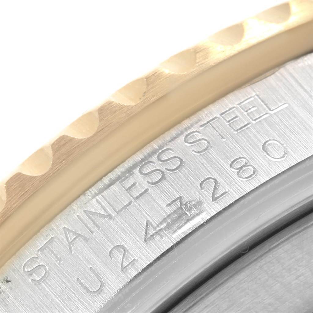 This close-up image shows the serial number and part of the bezel of a Rolex Submariner 16613 Men's Steel and Gold (two tone) Blue Dial 16613 Men's Steel and Gold (two tone) Blue Dial watch.