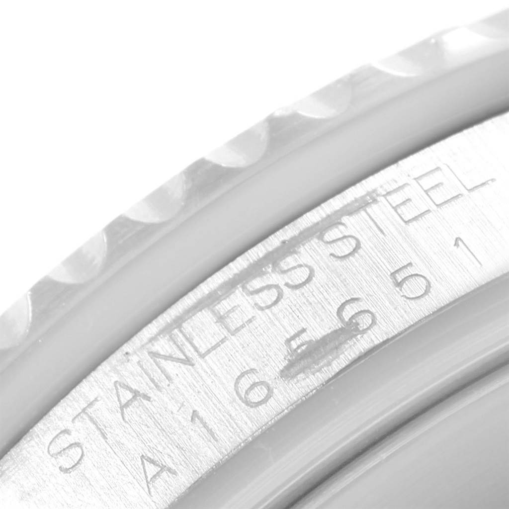 The image shows a close-up of the case's side detailing and serial number of a Rolex Submariner 16610 Men's Stainless Steel Black Dial 16610 Men's Stainless Steel Black Dial watch.