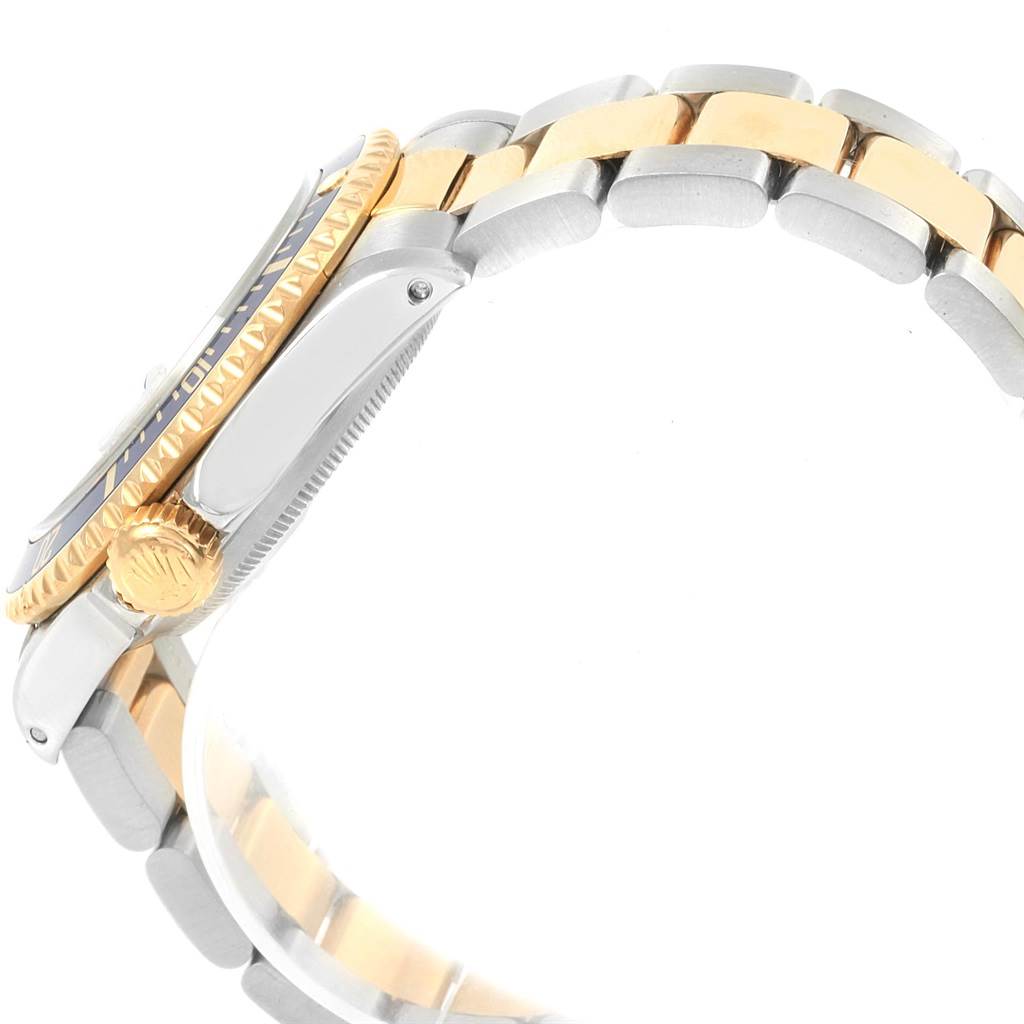 The image shows a side view of a Rolex Submariner 16613 Men's Steel and Gold (two tone) Blue Dial 16613 Men's Steel and Gold (two tone) Blue Dial watch with a two-tone metal bracelet and a gold crown.