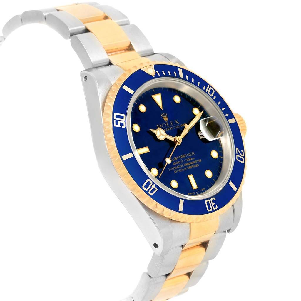The image shows an angled side view of a Rolex Submariner 16613 Men's Steel and Gold (two tone) Blue Dial 16613 Men's Steel and Gold (two tone) Blue Dial watch, highlighting its blue dial, bezel, and two-tone bracelet.
