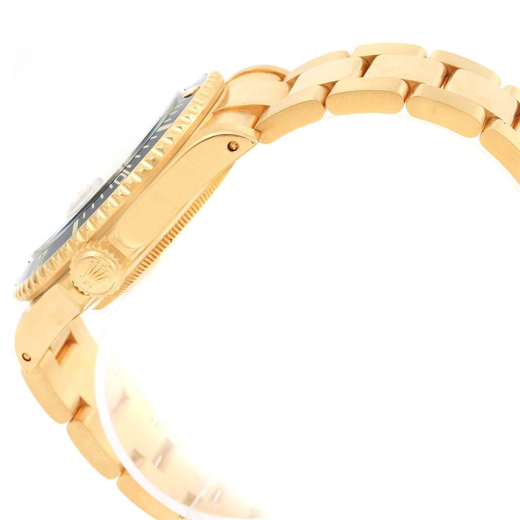 The image shows a side view of a Rolex Submariner 16618 Men's Yellow Gold Purple Dial 16618 Men's Yellow Gold Purple Dial watch, highlighting the crown, bezel, and part of the bracelet.