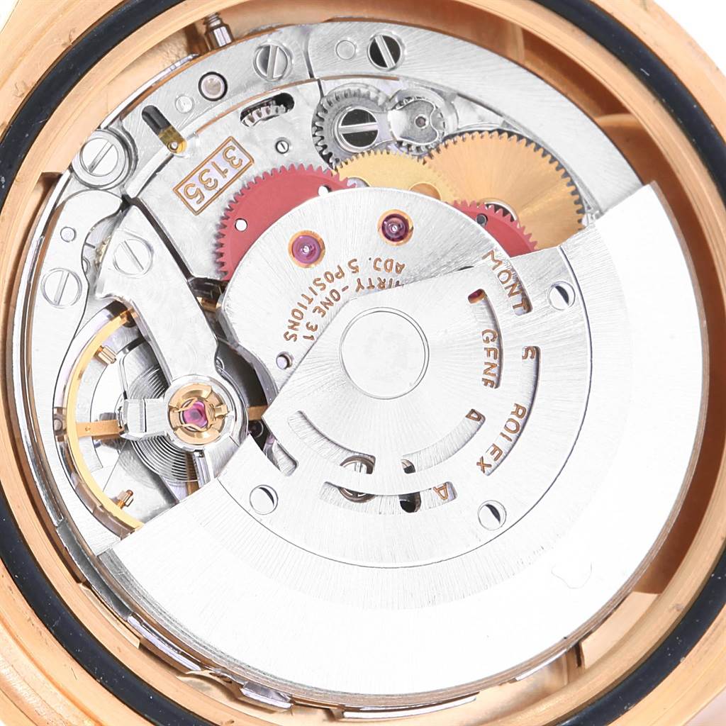 This image shows a close-up view of the movement inside the Rolex Submariner 16618 Men's Yellow Gold Purple Dial 16618 Men's Yellow Gold Purple Dial watch, highlighting its intricate mechanical components.