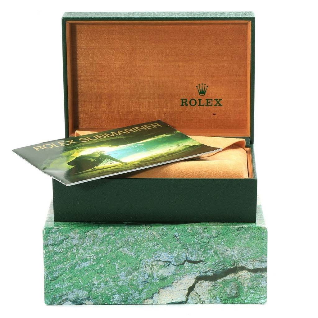 This image shows a Rolex Submariner 16803 Men's Steel and Gold (two tone) Blue Dial 16803 Men's Steel and Gold (two tone) Blue Dial box set, open to reveal its interior, with its booklet partially visible.