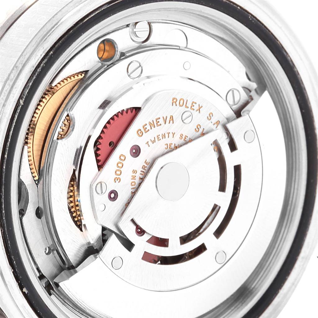 The image shows the intricate internal mechanism of the Rolex Submariner 14060 Men's Stainless Steel Black Dial 14060 Men's Stainless Steel Black Dial watch from a rear angle, highlighting its gears and movement parts.