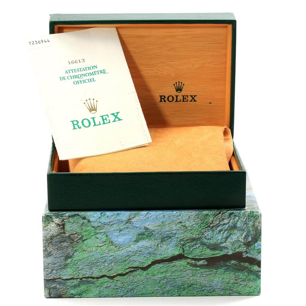 This image shows the open packaging box, certificate, and authentication documents for a Rolex Submariner 16613 Men's Steel and Gold (two tone) Black Dial 16613 Men's Steel and Gold (two tone) Black Dial watch.