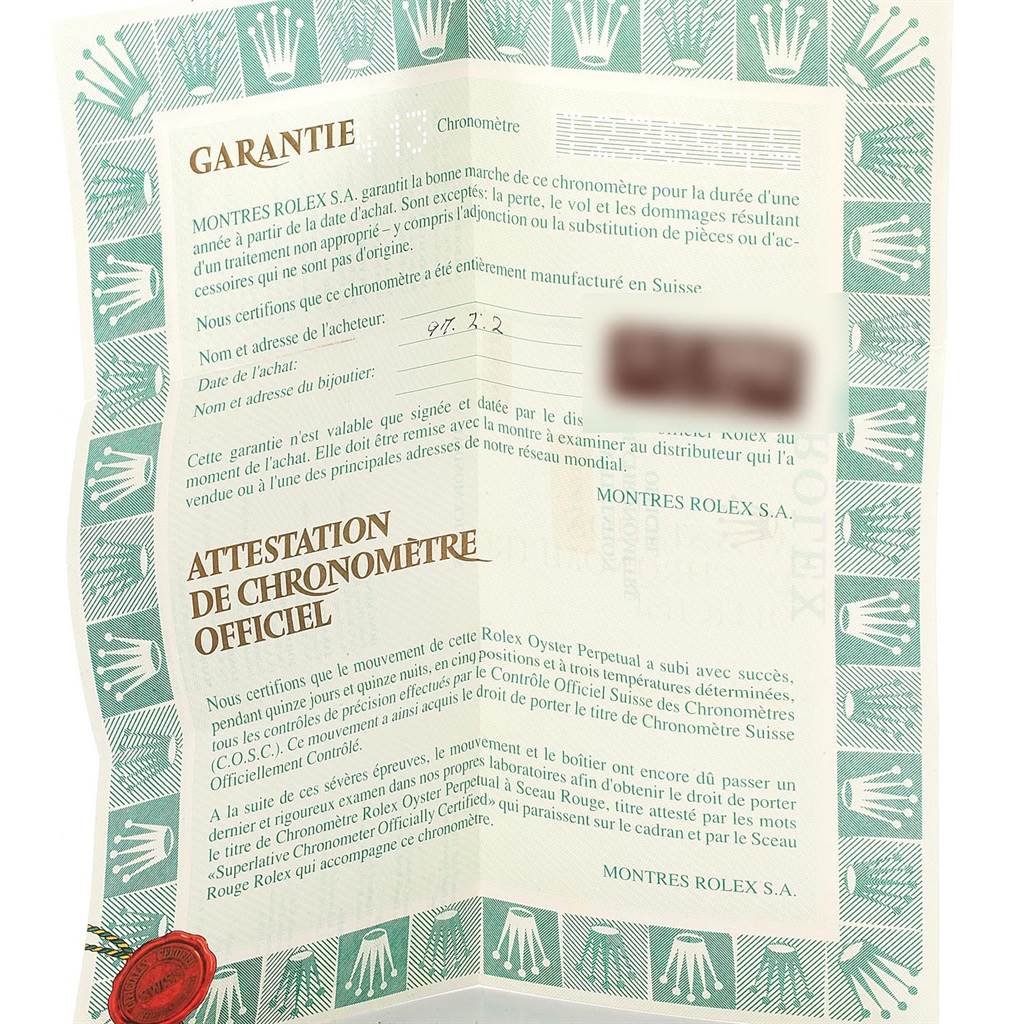 The image shows a warranty card for the Rolex Submariner 16613 Men's Steel and Gold (two tone) Black Dial 16613 Men's Steel and Gold (two tone) Black Dial watch, featuring text in French and bordered by green Rolex logos.