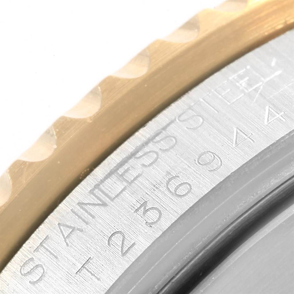 This image shows a close-up angle of the bezel and outer rim of a Rolex Submariner 16613 Men's Steel and Gold (two tone) Black Dial 16613 Men's Steel and Gold (two tone) Black Dial watch, highlighting the stainless steel material.