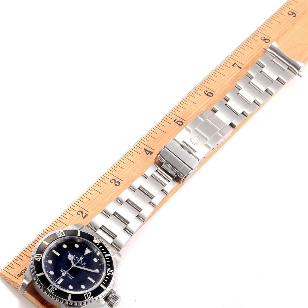 The image shows the full length of a Rolex Submariner 14060 Men's Stainless Steel Black Dial 14060 Men's Stainless Steel Black Dial watch and its bracelet, placed next to a ruler for scaling.