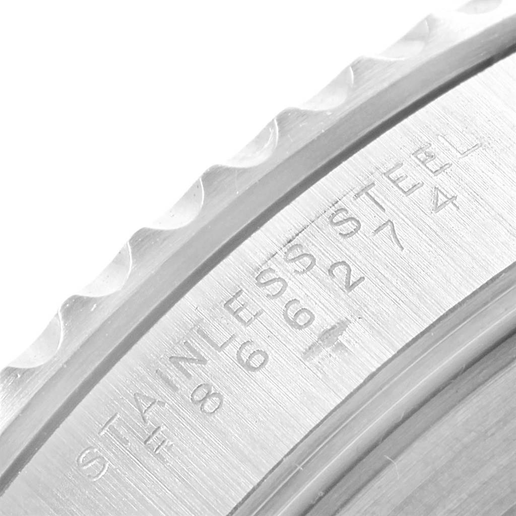 The image showcases a close-up of the engraved stainless steel bezel edge of a Rolex Submariner 14060 Men's Stainless Steel Black Dial 14060 Men's Stainless Steel Black Dial watch.