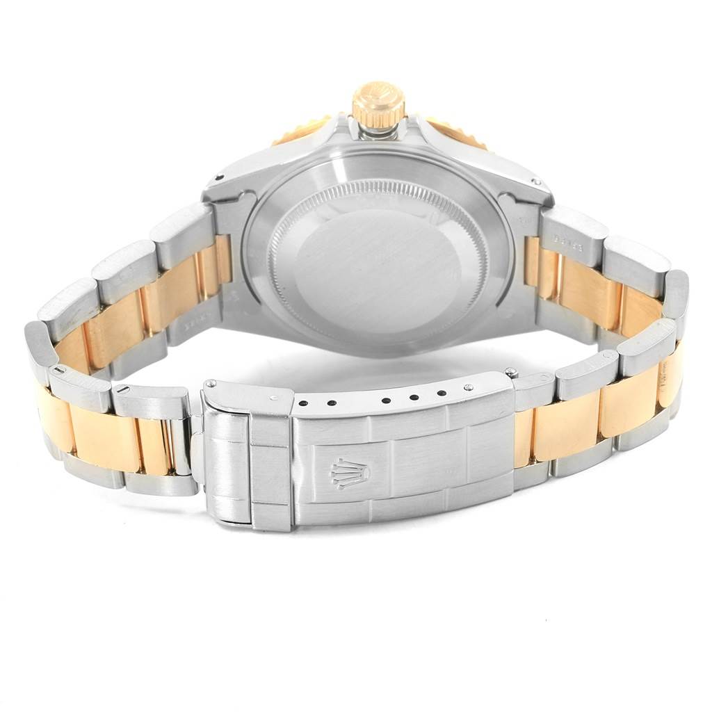 This image shows the backside and clasp of a Rolex Submariner 16613 Men's Steel and Gold (two tone) Black Dial 16613 Men's Steel and Gold (two tone) Black Dial watch, highlighting the two-tone bracelet and case back.