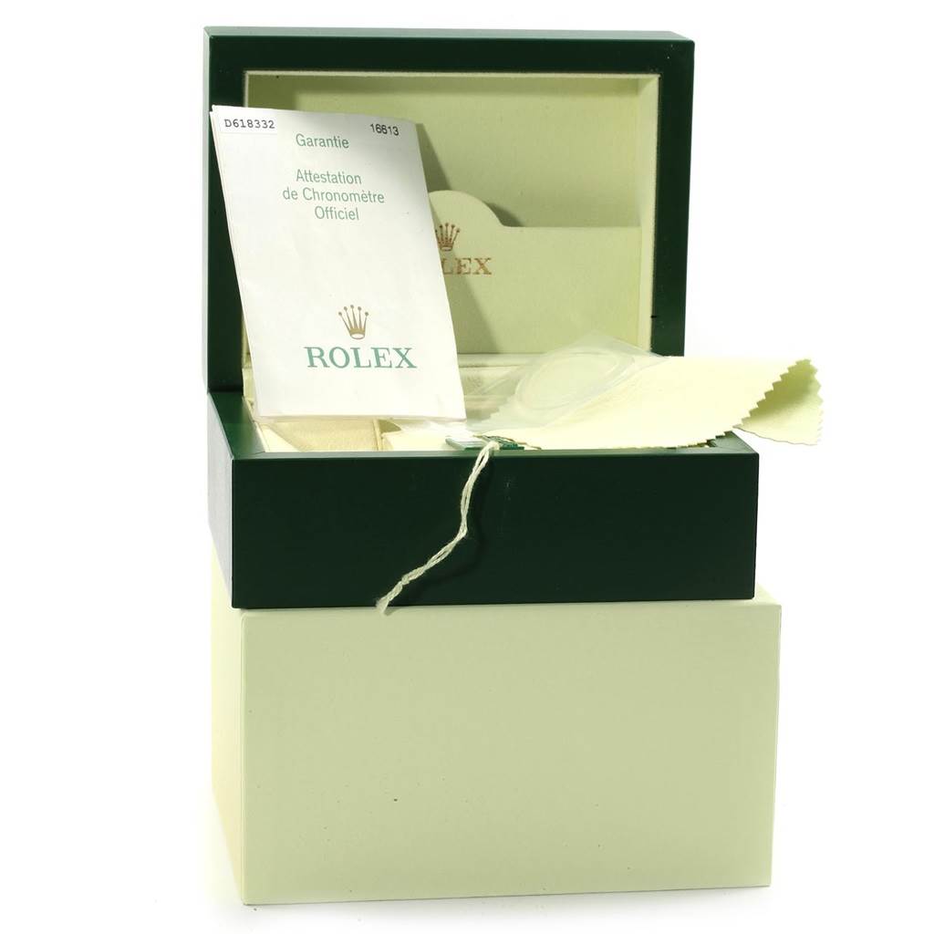 The image displays a Rolex Submariner 16613 Men's Steel and Gold (two tone) Black Dial 16613 Men's Steel and Gold (two tone) Black Dial packaging box with warranty cards and a cleaning cloth inside.