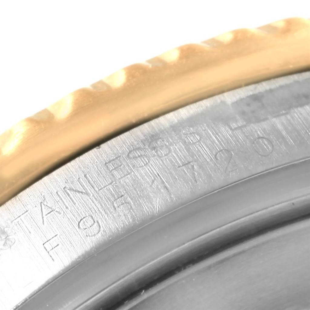 Close-up of the side of a Rolex Submariner 16613 Men's Steel and Gold (two tone) Blue Dial 16613 Men's Steel and Gold (two tone) Blue Dial, showing its stainless steel case and gold bezel.