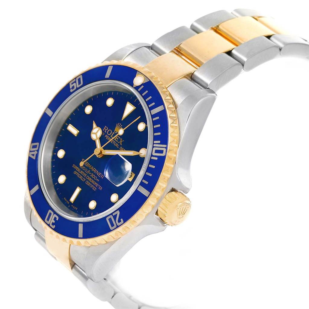 The image shows a Rolex Submariner 16613 Men's Steel and Gold (two tone) Blue Dial 16613 Men's Steel and Gold (two tone) Blue Dial watch at an angled view, highlighting the blue dial, bezel, crown, and two-tone bracelet.