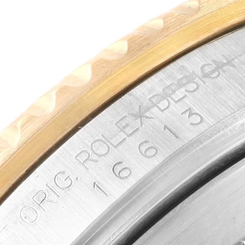 The image shows a close-up of the bezel and engraved caseback of a Rolex Submariner 16613 Men's Steel and Gold (two tone) Blue Dial 16613 Men's Steel and Gold (two tone) Blue Dial watch, highlighting the model and design details.