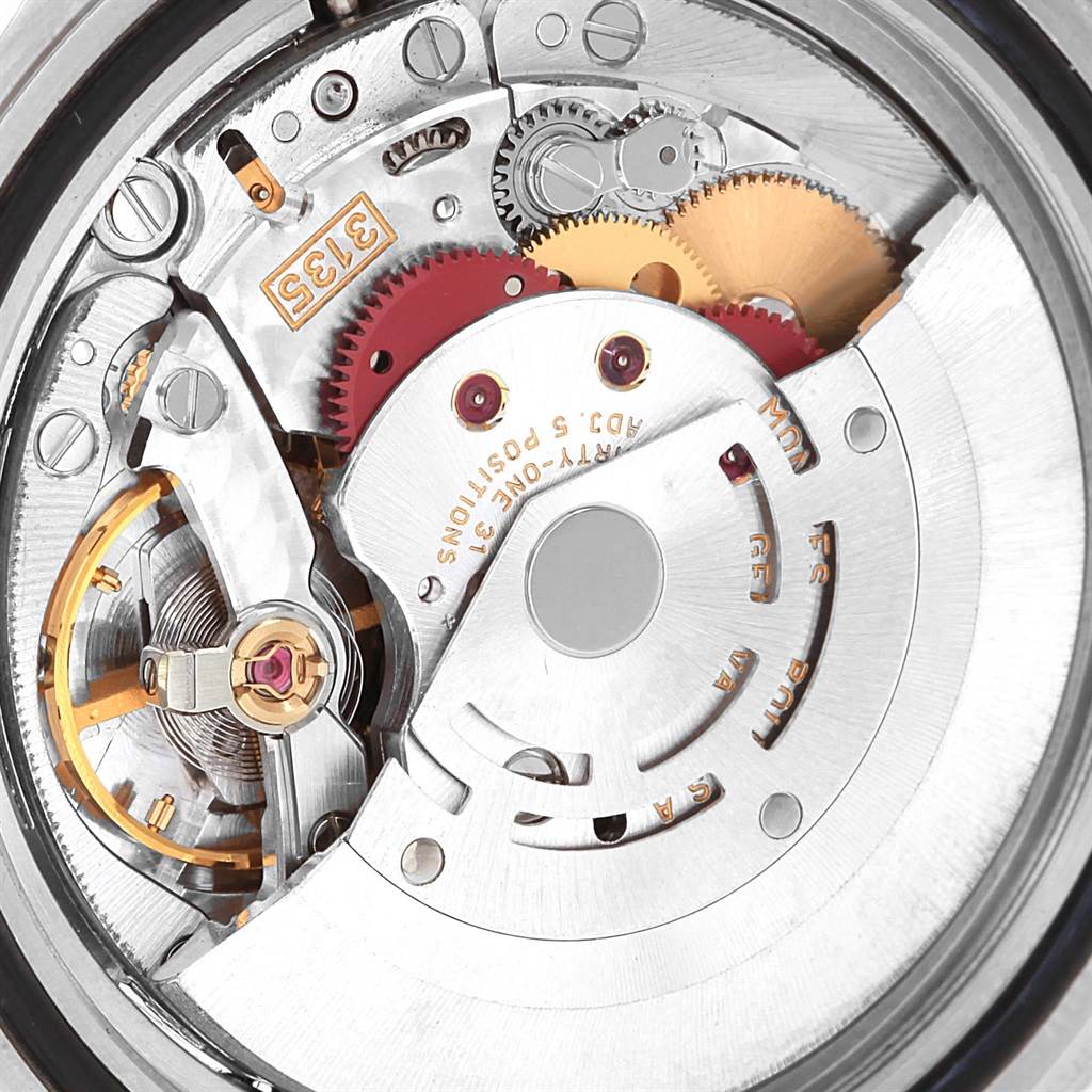 This angle shows a close-up view of the movement inside a Rolex Submariner 16613 Men's Steel and Gold (two tone) Blue Dial 16613 Men's Steel and Gold (two tone) Blue Dial watch, featuring gears and mechanisms.