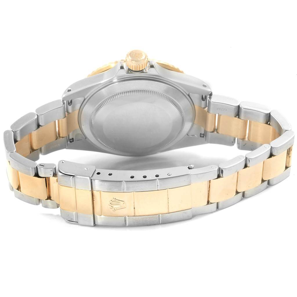 The image shows the backside of the Rolex Submariner 16613 Men's Steel and Gold (two tone) Blue Dial 16613 Men's Steel and Gold (two tone) Blue Dial watch, focusing on the case back, crown, and two-tone bracelet.