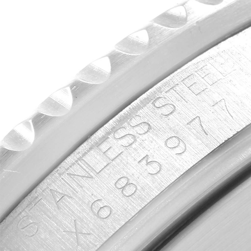 The image shows a close-up of the engraving and knurled edge of the Rolex Submariner 16610 Men's Stainless Steel Black Dial 16610 Men's Stainless Steel Black Dial watch's bezel.