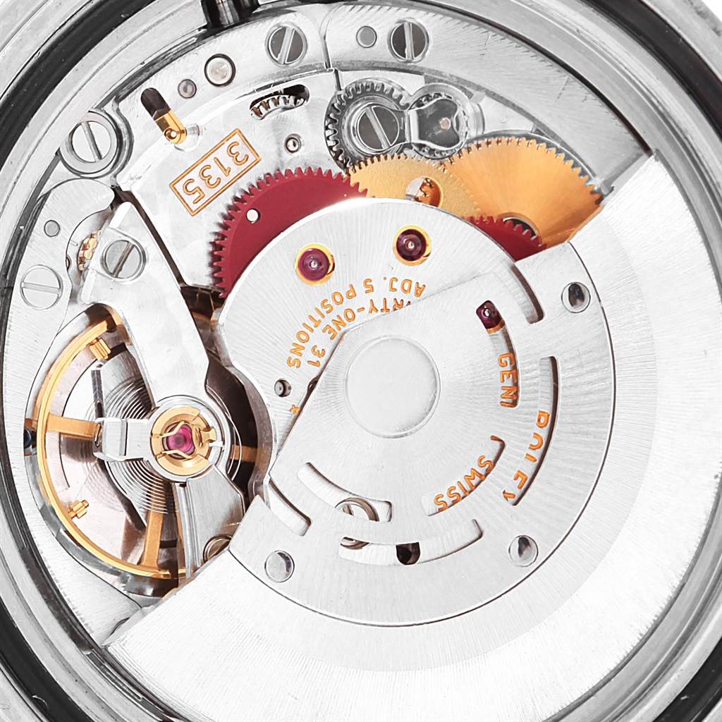 This is a close-up of the internal mechanism of a Rolex Submariner 16610 Men's Stainless Steel Black Dial 16610 Men's Stainless Steel Black Dial watch, showing gears and the rotor.