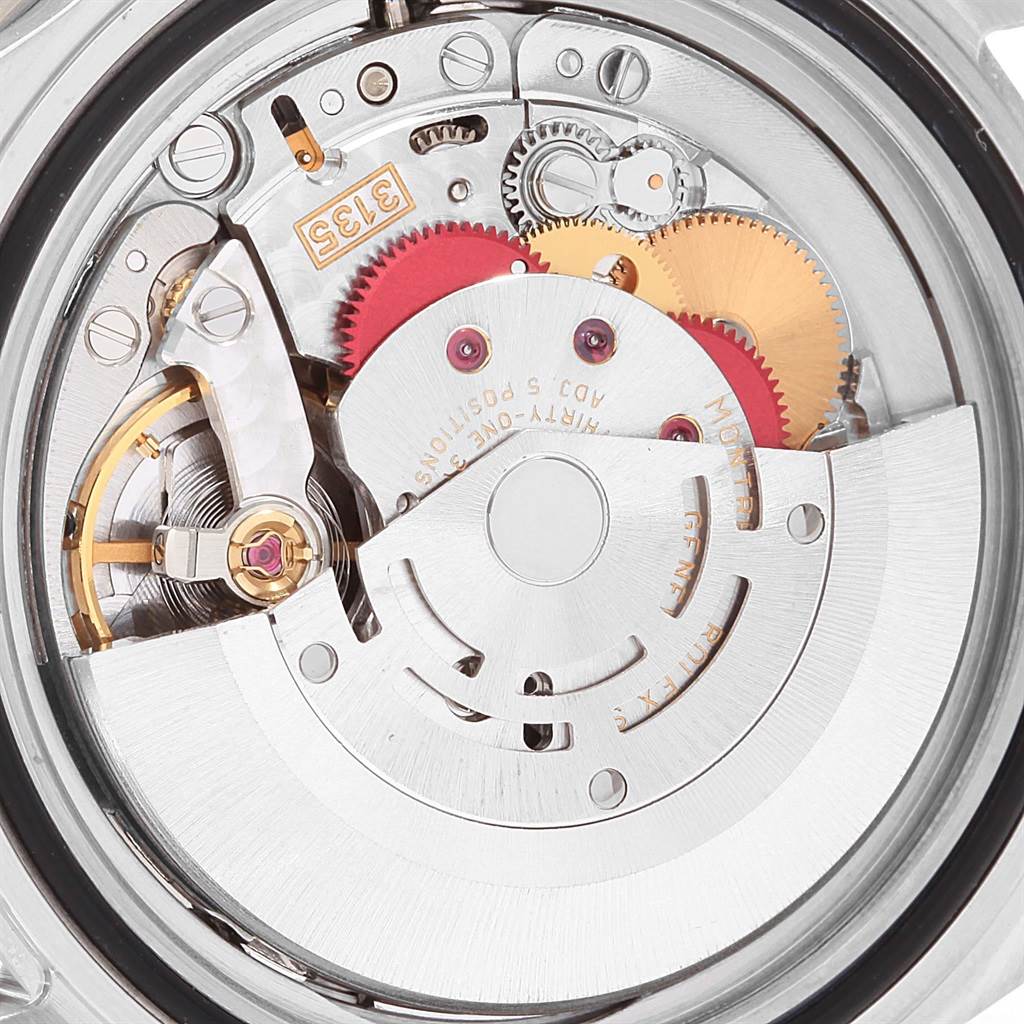 The image shows an internal view of the Rolex Submariner 16610 Men's Stainless Steel Black Dial 16610 Men's Stainless Steel Black Dial model's watch movement, highlighting gears and mechanical components.
