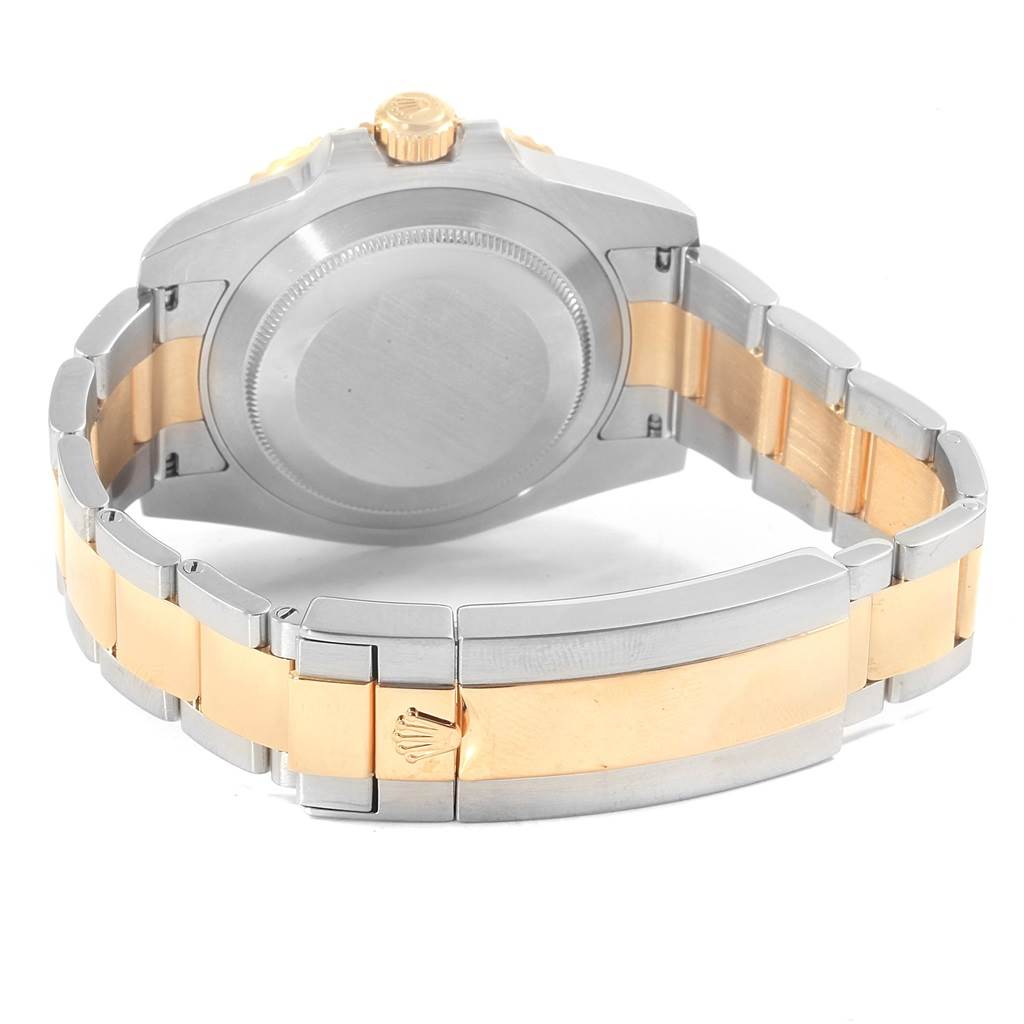 This image shows the back case, crown, and two-tone bracelet of a Rolex Submariner 116613 Men's Steel and Gold (two tone) Black Dial 116613 Men's Steel and Gold (two tone) Black Dial watch.