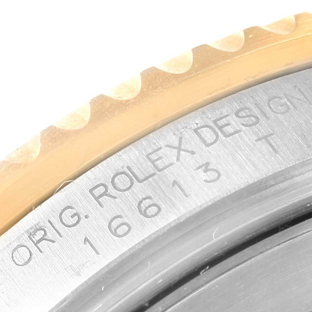 This close-up image shows the engraved serial number and partial bezel of a Rolex Submariner 16613 Men's Steel and Gold (two tone) Champagne Dial 16613 Men's Steel and Gold (two tone) Champagne Dial watch.