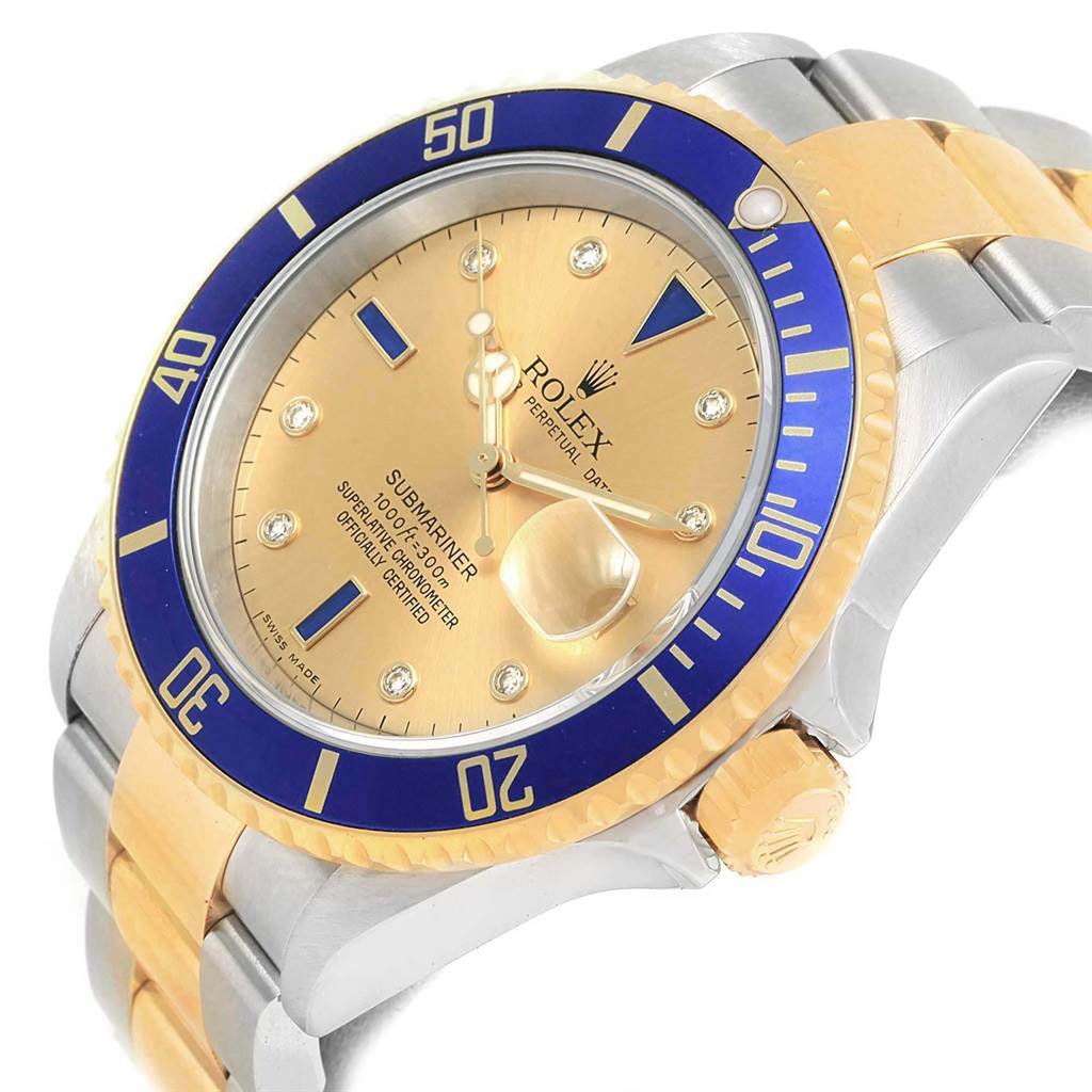 The image shows a close-up angle of a Rolex Submariner 16613 Men's Steel and Gold (two tone) Champagne Dial 16613 Men's Steel and Gold (two tone) Champagne Dial watch, highlighting its blue and gold bezel, dial, crown, and bracelet.