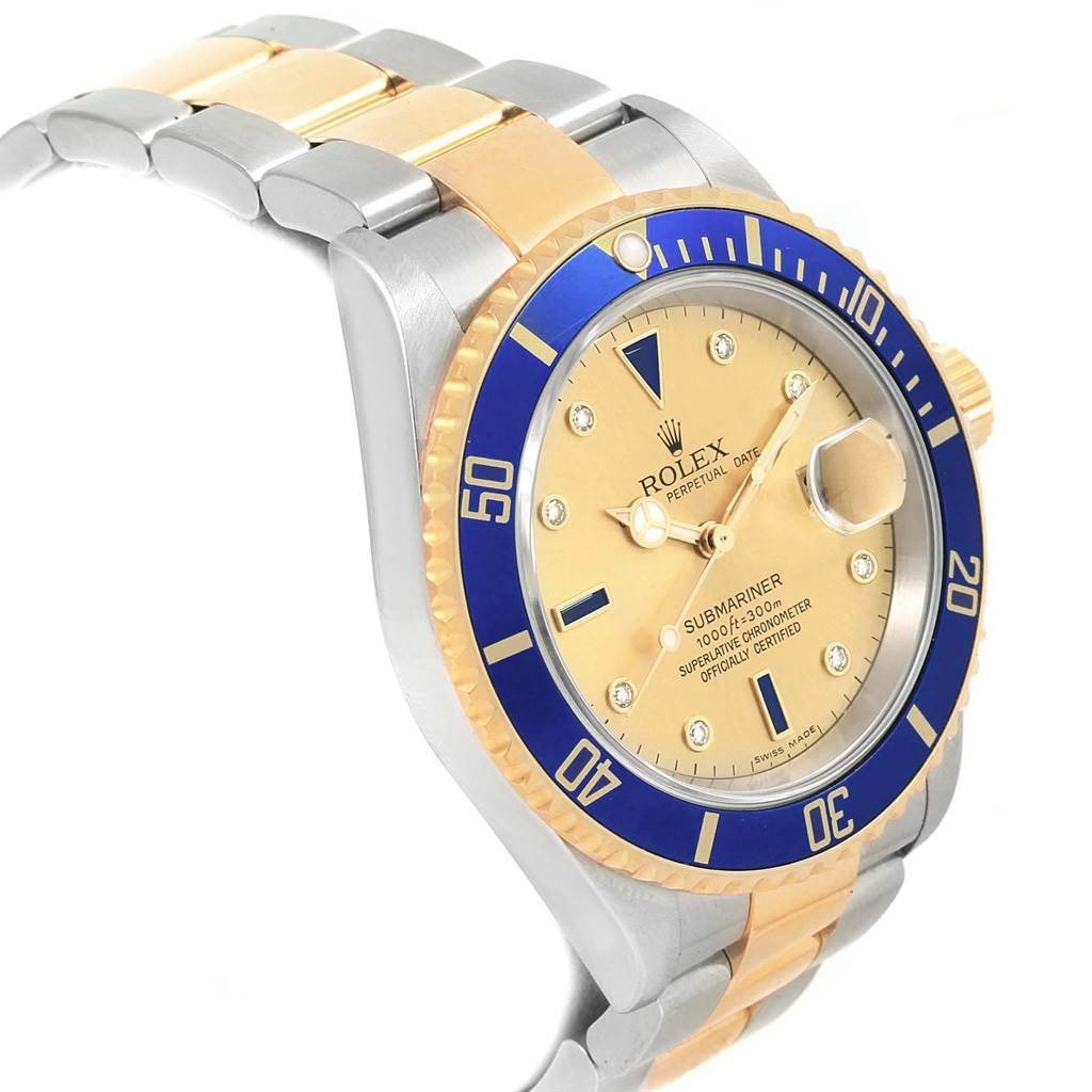The Rolex Submariner 16613 Men's Steel and Gold (two tone) Champagne Dial 16613 Men's Steel and Gold (two tone) Champagne Dial watch is shown from a side view, highlighting its bezel, dial, case, and two-tone bracelet.