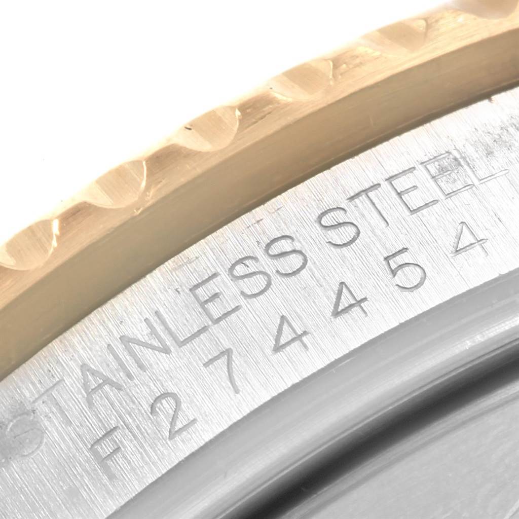 This close-up image shows the engraved serial number and part of the bezel on a Rolex Submariner 16613 Men's Steel and Gold (two tone) Champagne Dial 16613 Men's Steel and Gold (two tone) Champagne Dial watch.