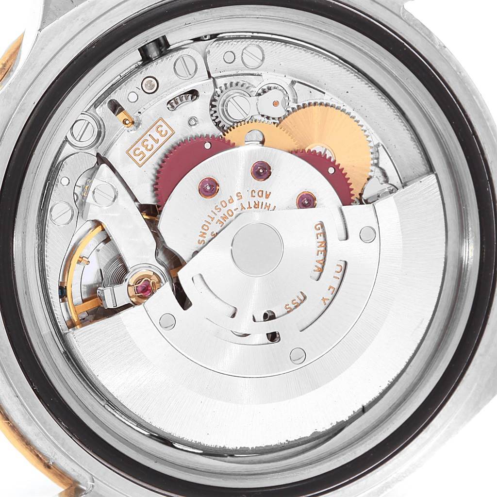 The image shows the internal mechanism and movement of a Rolex Submariner 16613 Men's Steel and Gold (two tone) Champagne Dial 16613 Men's Steel and Gold (two tone) Champagne Dial watch from a back angle.