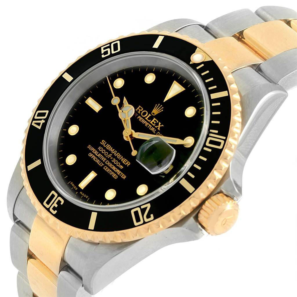 The image shows a close-up, oblique angle of the Rolex Submariner 16613 Men's Steel and Gold (two tone) Black Dial 16613 Men's Steel and Gold (two tone) Black Dial watch, highlighting its black dial, bezel, and two-tone bracelet.