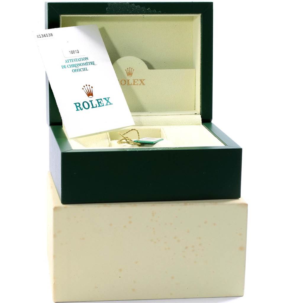 The image shows a green Rolex Submariner 16613 Men's Steel and Gold (two tone) Black Dial 16613 Men's Steel and Gold (two tone) Black Dial box with a certification card and tag inside.