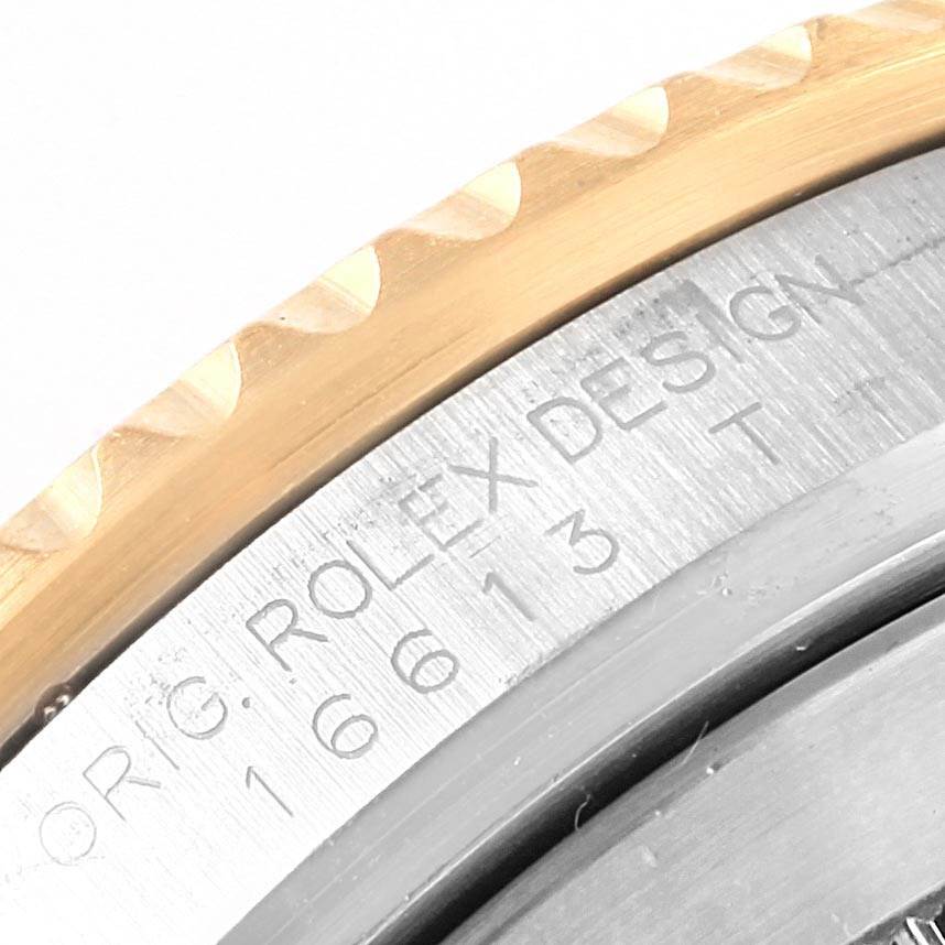 The image shows a close-up of the bezel and case detailing of a Rolex Submariner 16613 Men's Steel and Gold (two tone) Black Dial 16613 Men's Steel and Gold (two tone) Black Dial watch, displaying the "ROLEX DESIGN" engraving and model number.