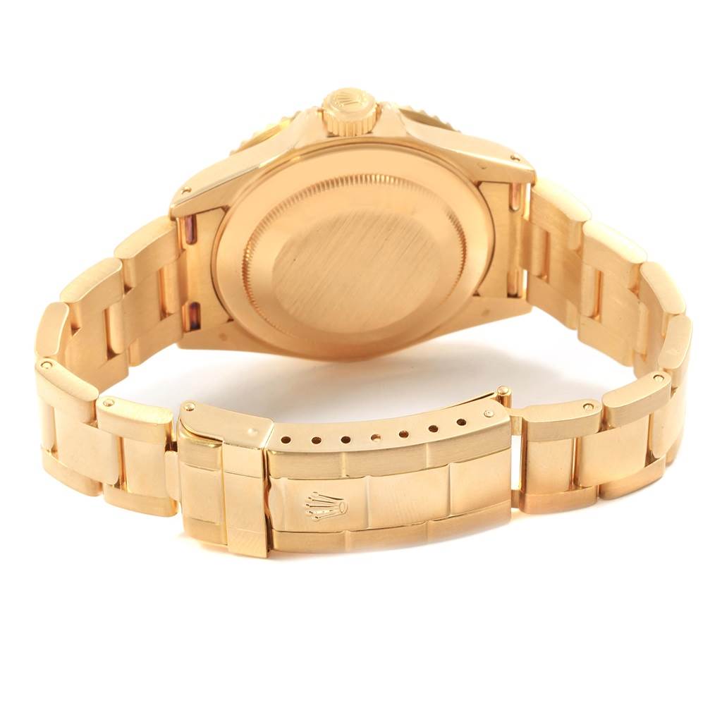 This image shows the back and clasp of a Rolex Submariner 16618 Men's Yellow Gold Champagne Dial 16618 Men's Yellow Gold Champagne Dial watch, highlighting its gold bracelet and case.
