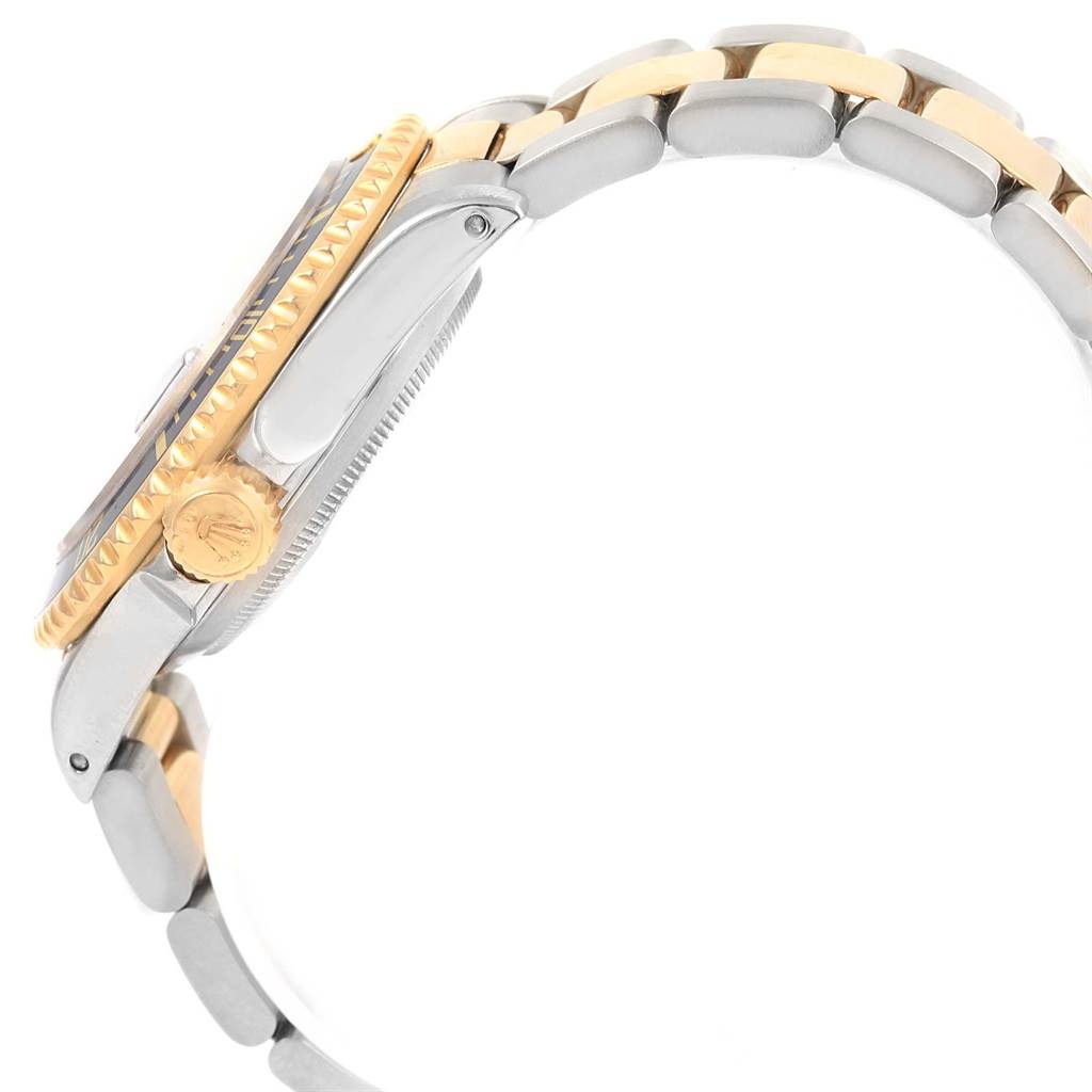 The image shows a side profile of a Rolex Submariner 16613 Men's Steel and Gold (two tone) Blue Dial 16613 Men's Steel and Gold (two tone) Blue Dial, highlighting the crown, bezel, and part of the two-tone bracelet.