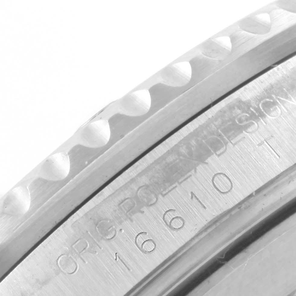 The image shows a close-up of the bezel and serial engraving on a Rolex Submariner 16610 Men's Stainless Steel Black Dial 16610 Men's Stainless Steel Black Dial watch.