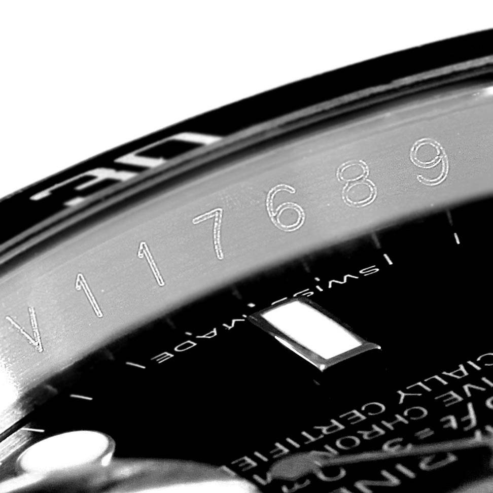 This close-up angle of the Rolex Submariner 16610 Men's Stainless Steel Black Dial 16610 Men's Stainless Steel Black Dial shows the rehaut with the engraved serial number and part of the watch face.