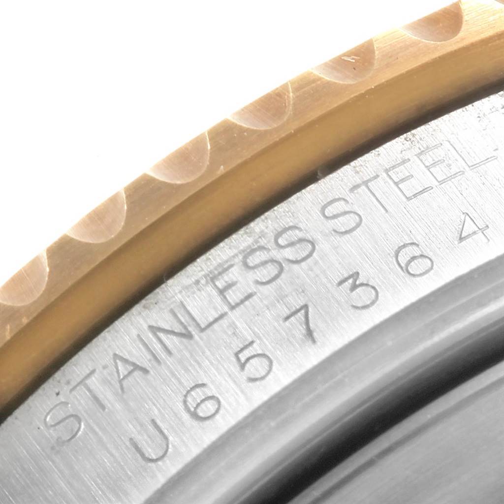 The image shows a close-up of the stainless steel case and bezel of a Rolex Submariner 16613 Men's Steel and Gold (two tone) Grey Dial 16613 Men's Steel and Gold (two tone) Grey Dial watch.